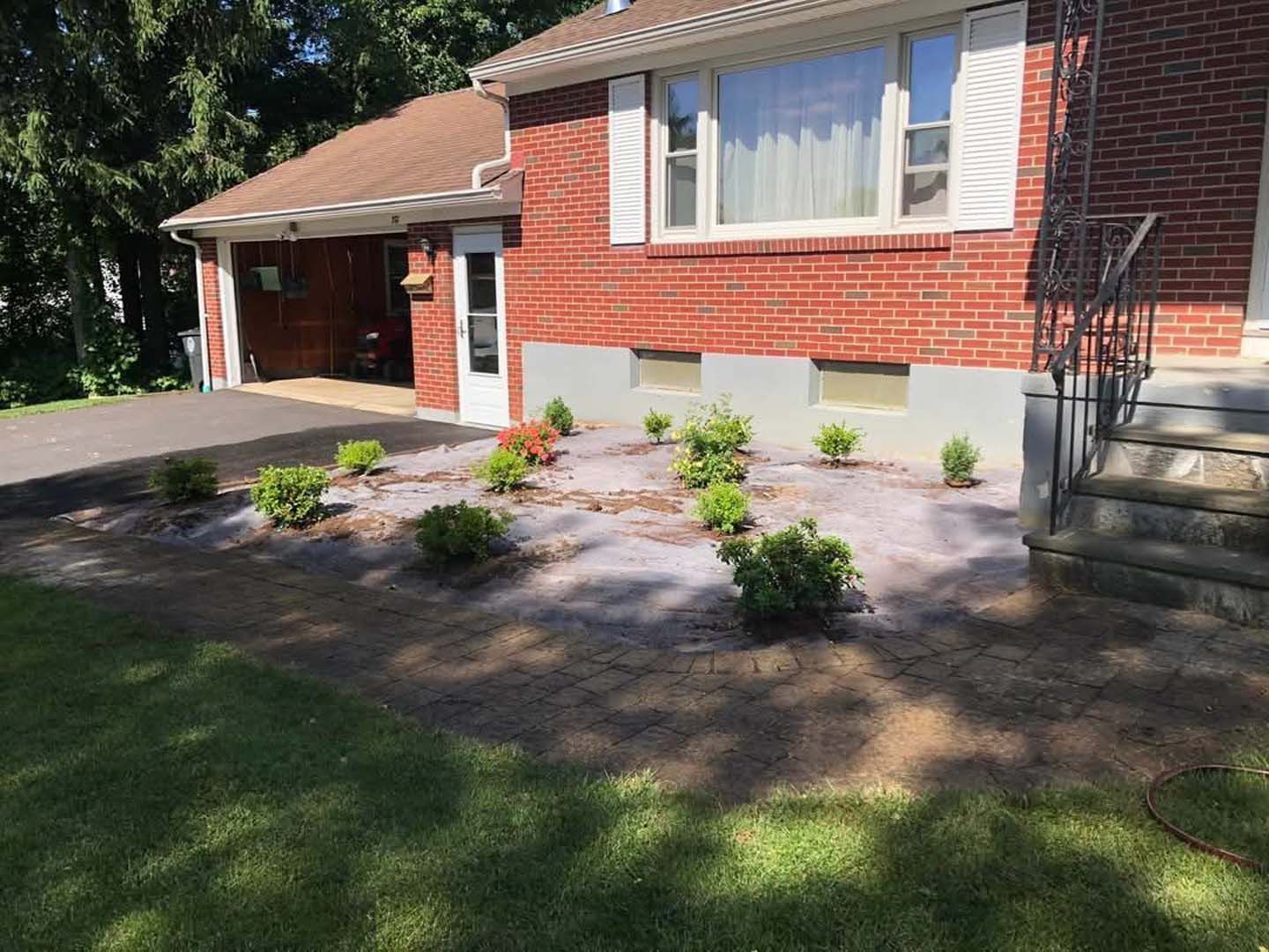 A brick house with a garden in front of it.