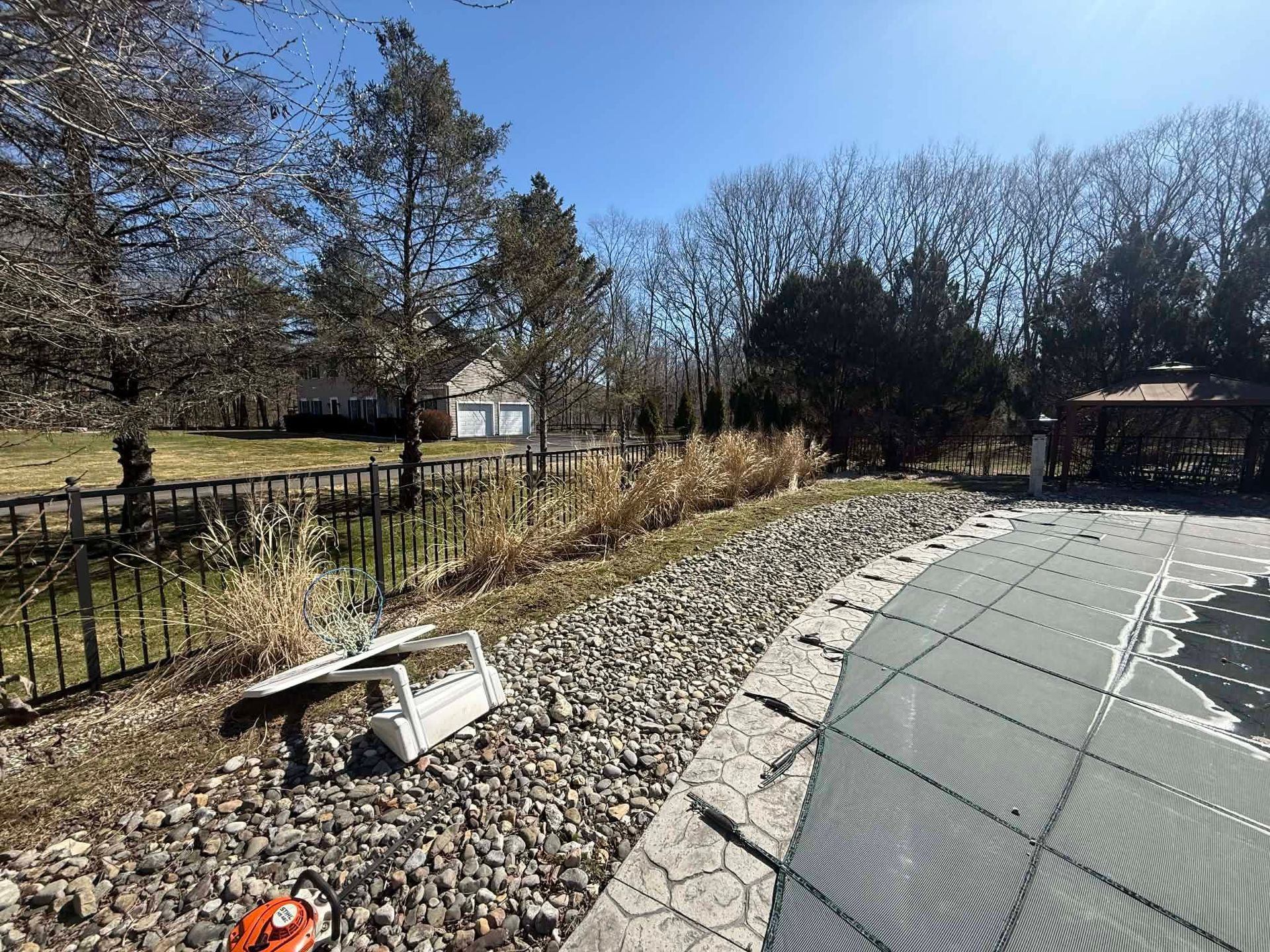 A backyard with a gazebo and a fire pit