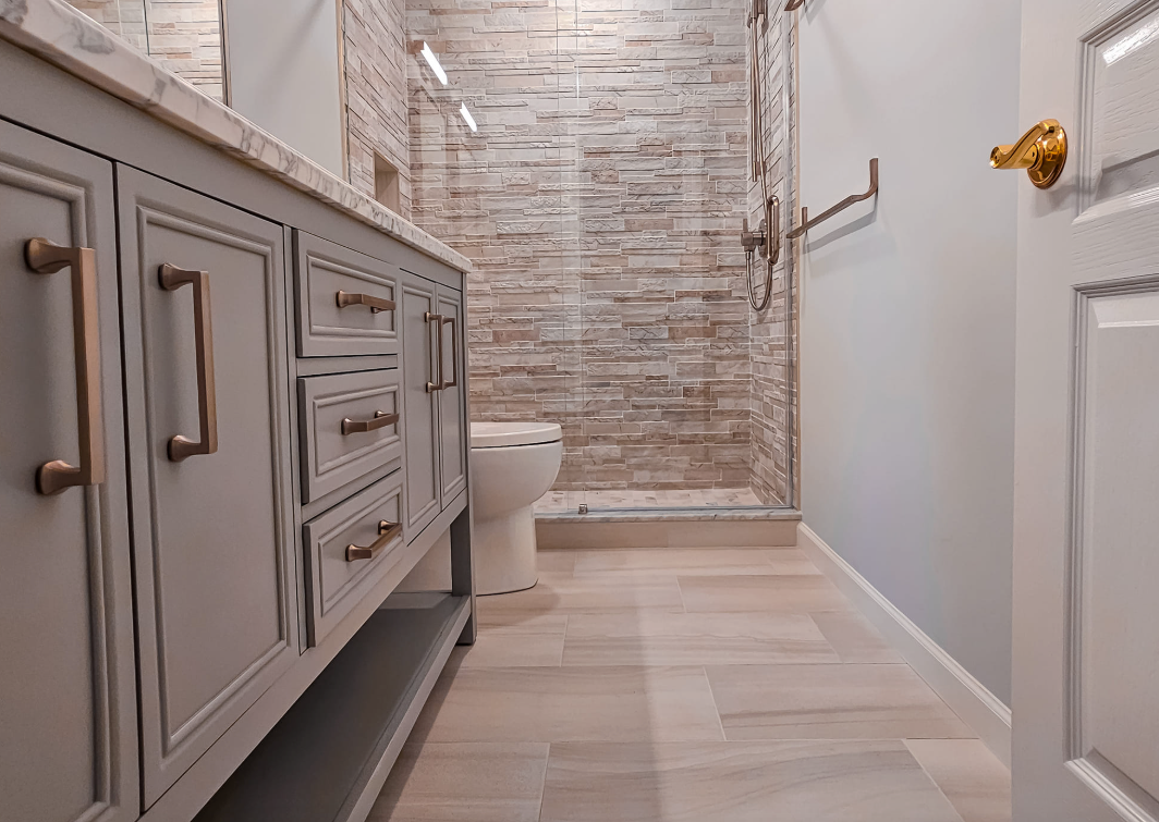 A bathroom with a toilet , sink , and walk in shower.