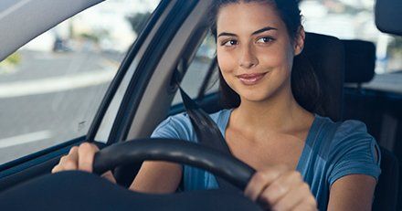 south coast driving school lady wearing seat belt and looking at the rear view mirror 