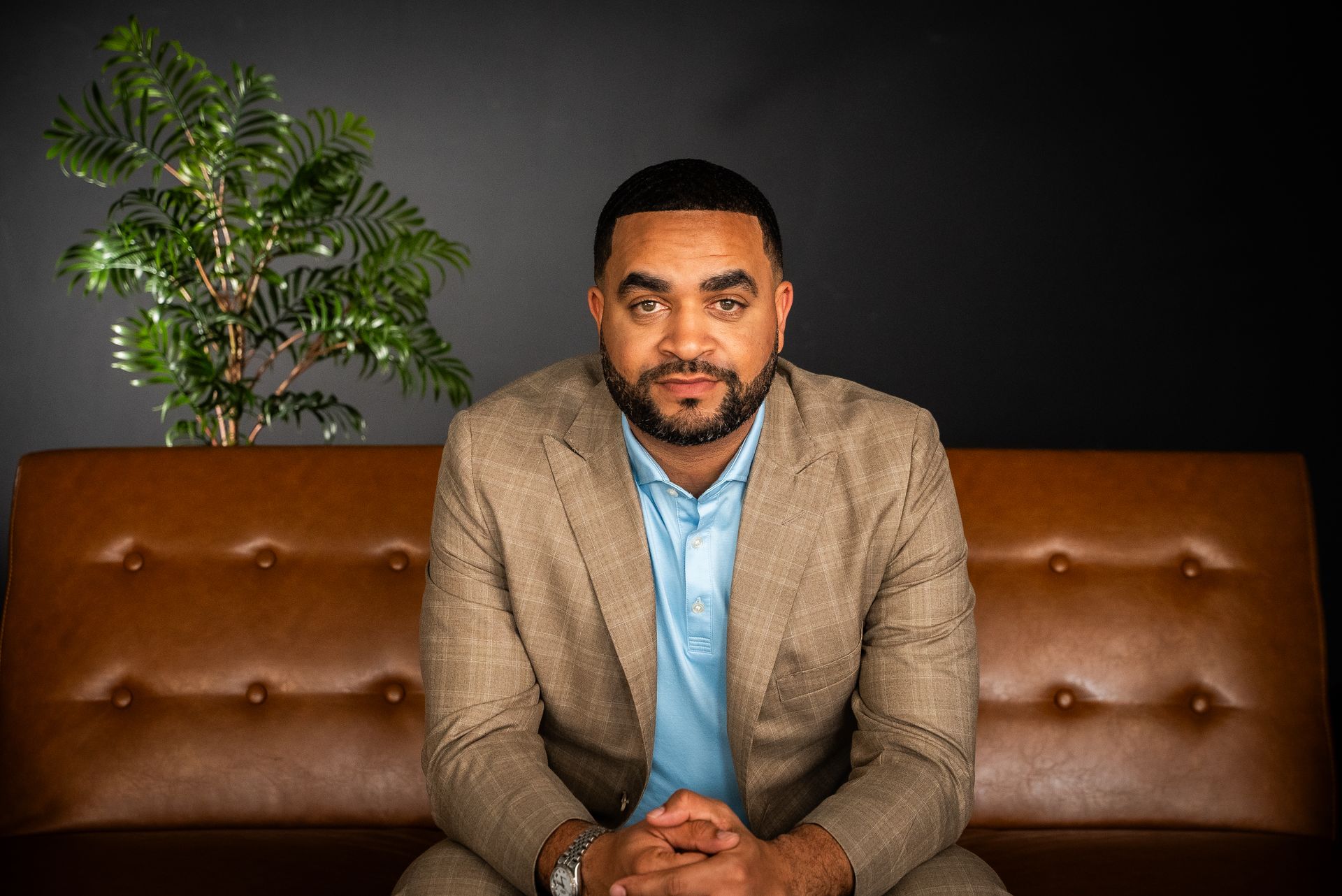 Palm trees frame tall city skyscrapers against a bright, sunny sky.