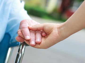 Assisted Living — Care Taker Holding a Hand of a Senior in Reno, NV