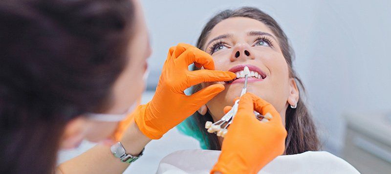 dental assistant with implant samples