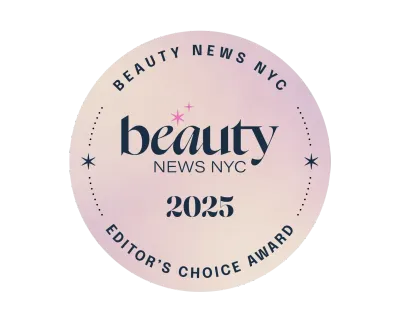 Circular "Beauty News NYC 2025 Editor's Choice Award" badge on a soft, gradient pink background.