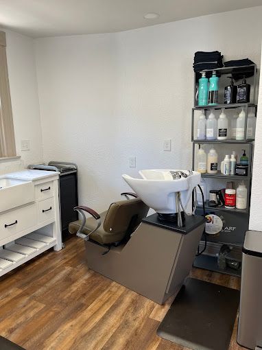 A hair salon with a sink and a chair.