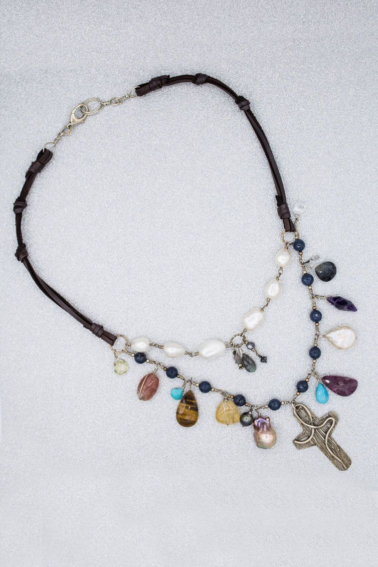 A necklace with many beads and a cross pendant