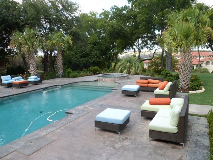 A swimming pool with a lot of furniture around it