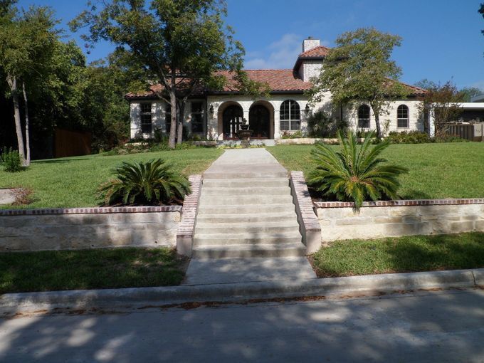 A large house with stairs leading up to it