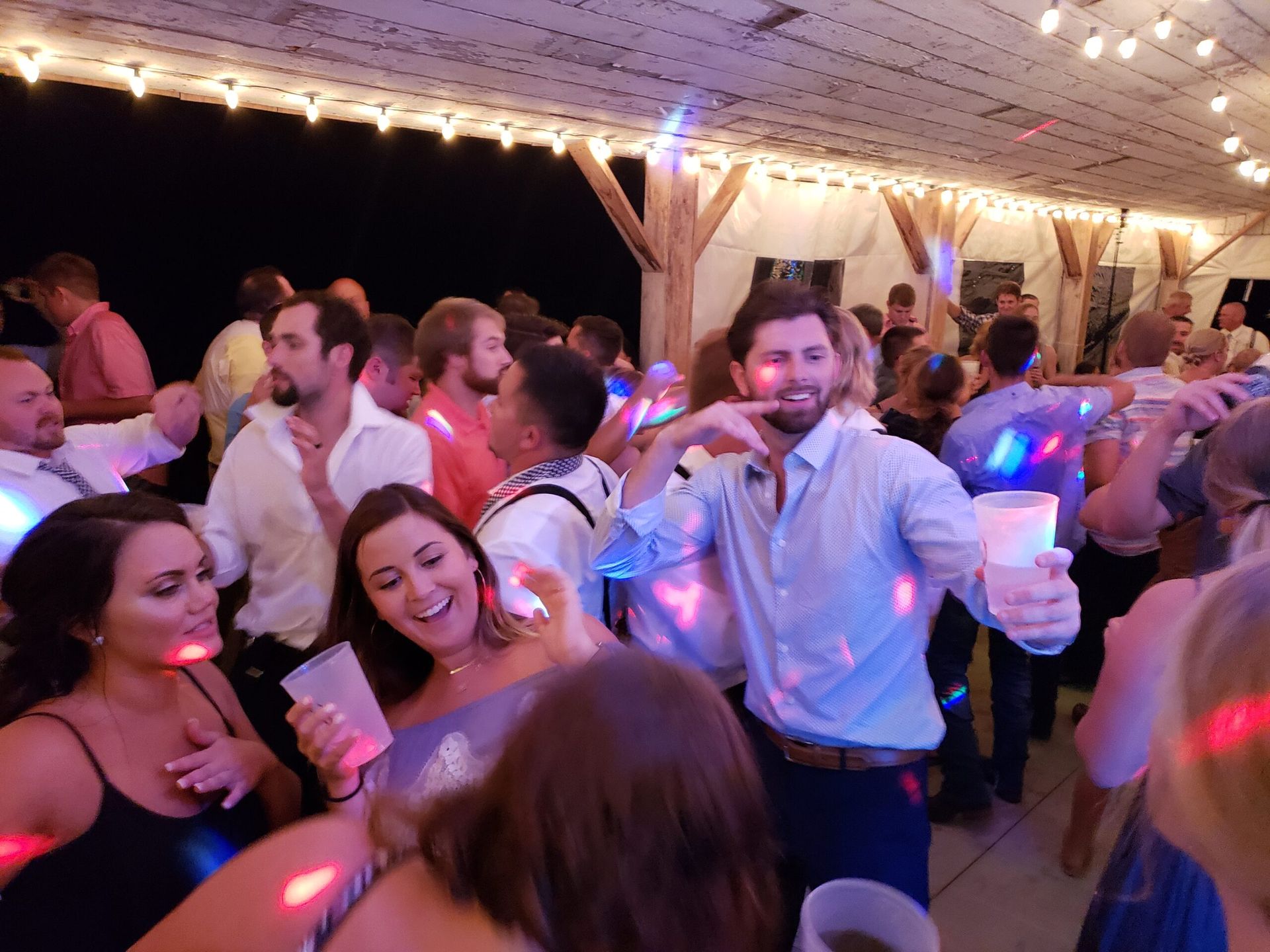 A large group of people are dancing at a party.