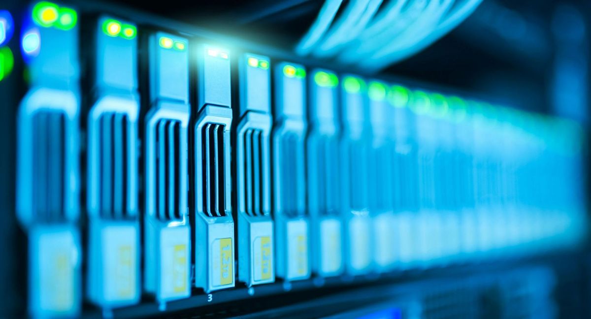 A row of servers in a data center with blue lights on them.
