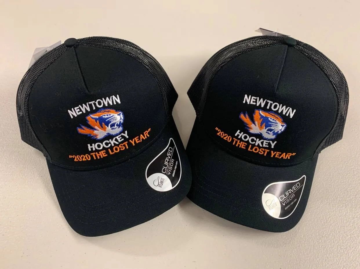 Two Newtown Hockey Hats Are Sitting On A Table — Sportstar Screenprinting In Newtown, QLD