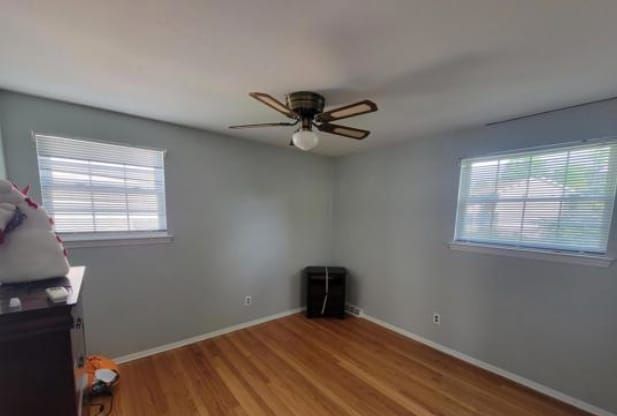 There is a ceiling fan in the corner of the room.