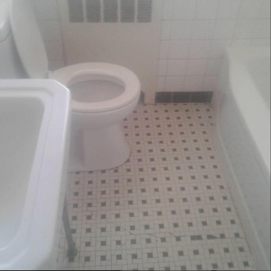 A bathroom with a toilet a sink and a bathtub