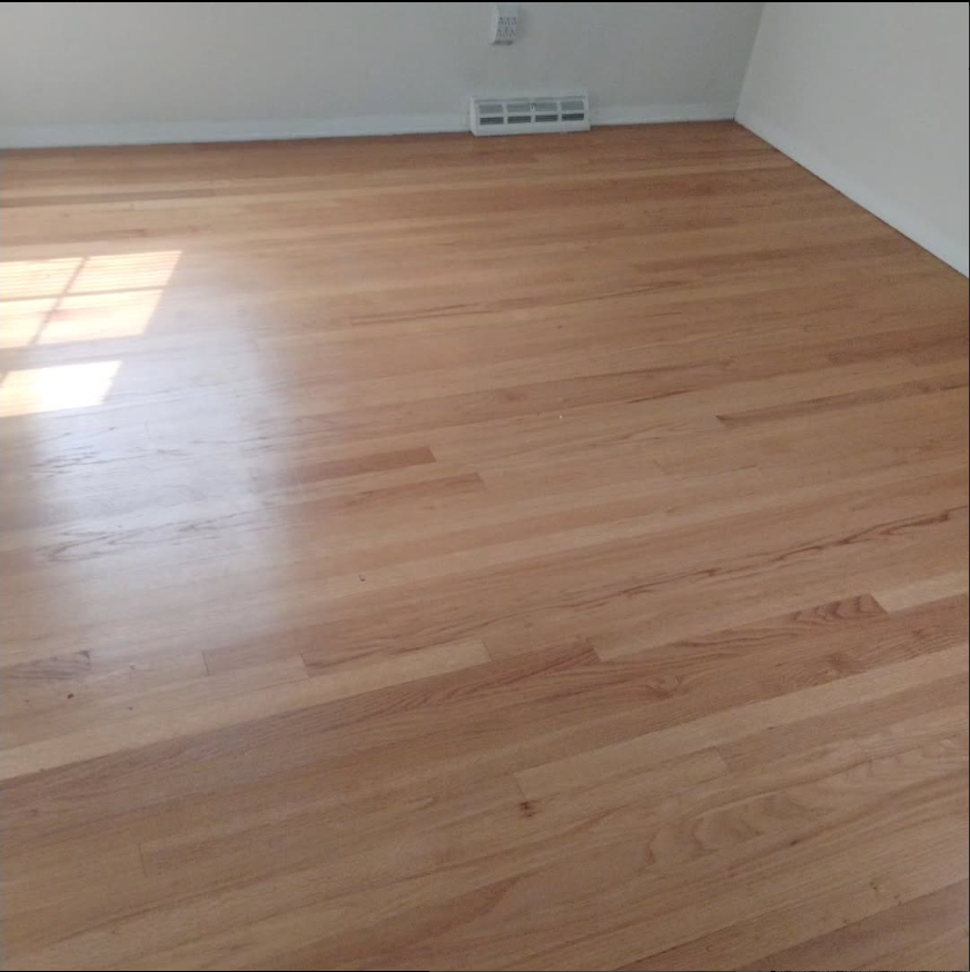 A room with a wooden floor and a window