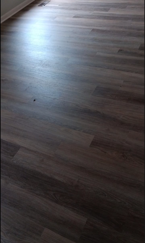 A close up of a wooden floor in a room.