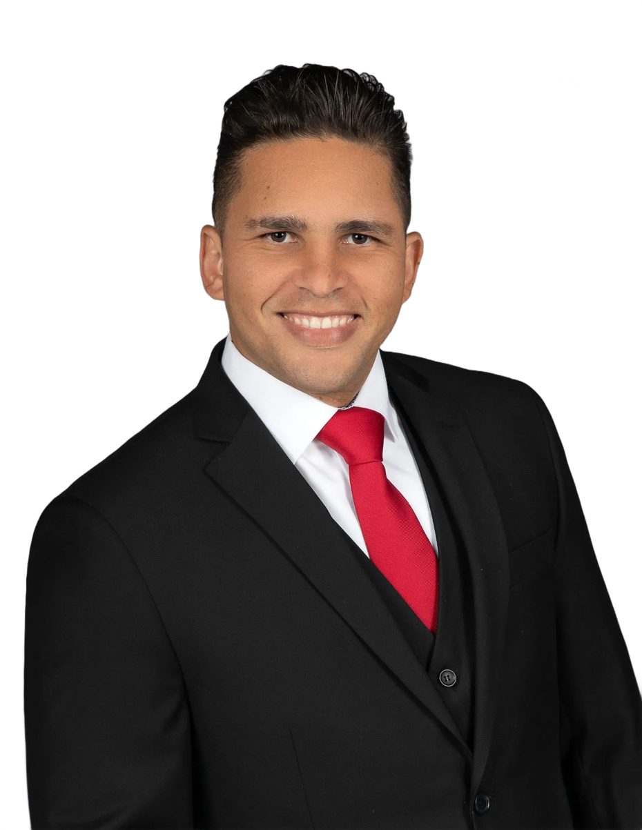 Man in a black suit with red tie smiling.