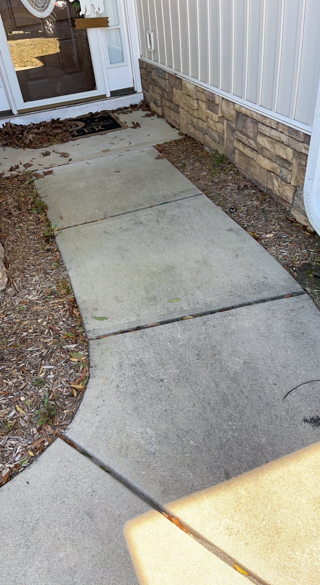 A concrete walkway leading to a mobile home.