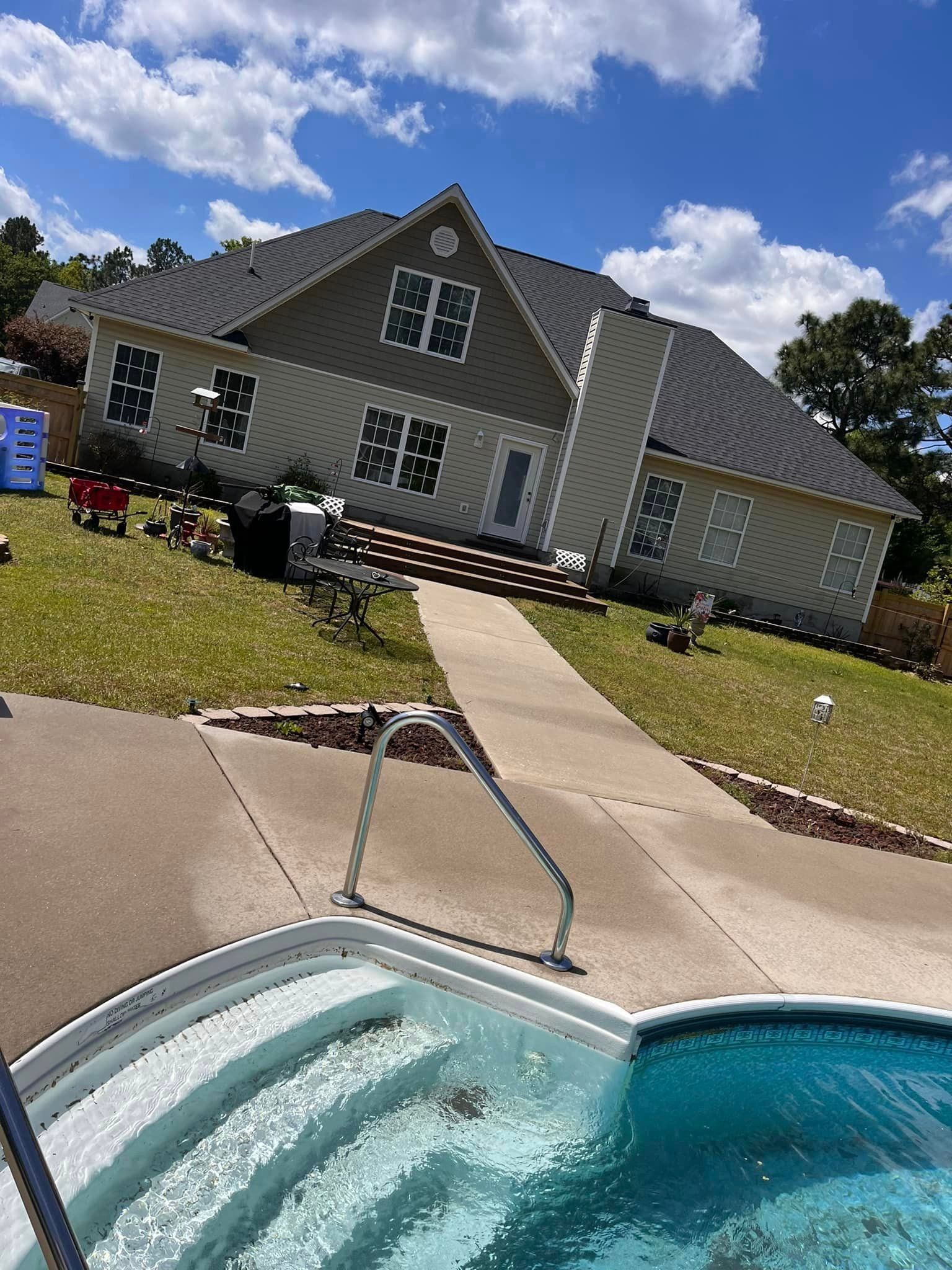 A large house with a swimming pool in front of it.