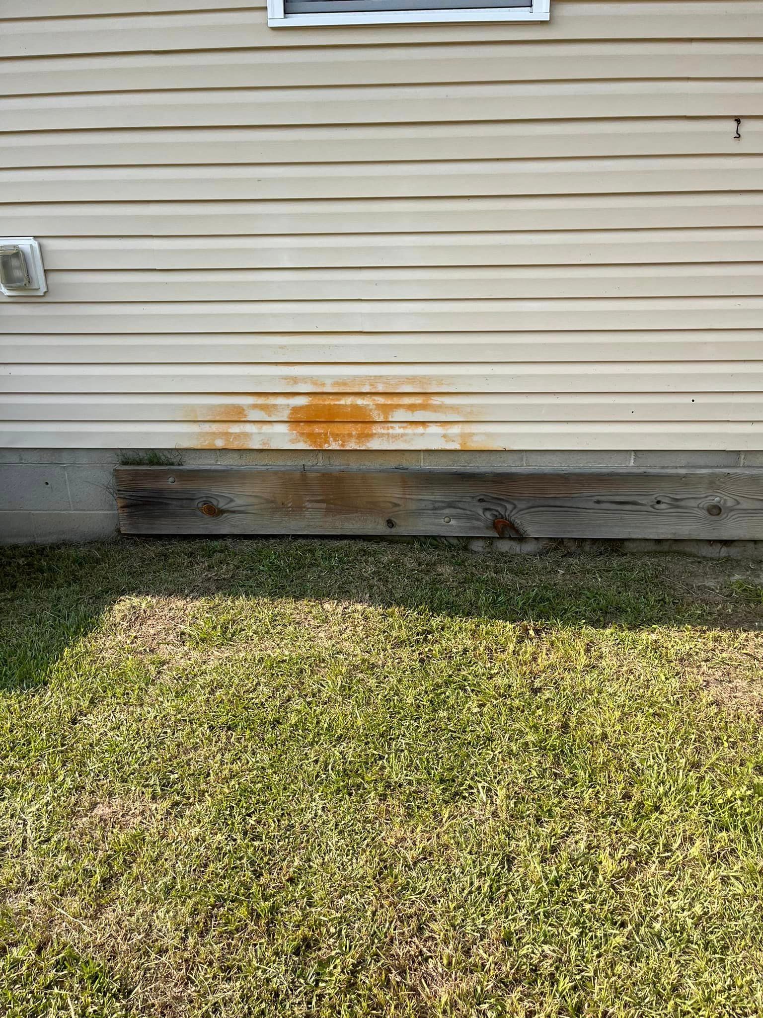 A house with a lot of rust on the side of it.