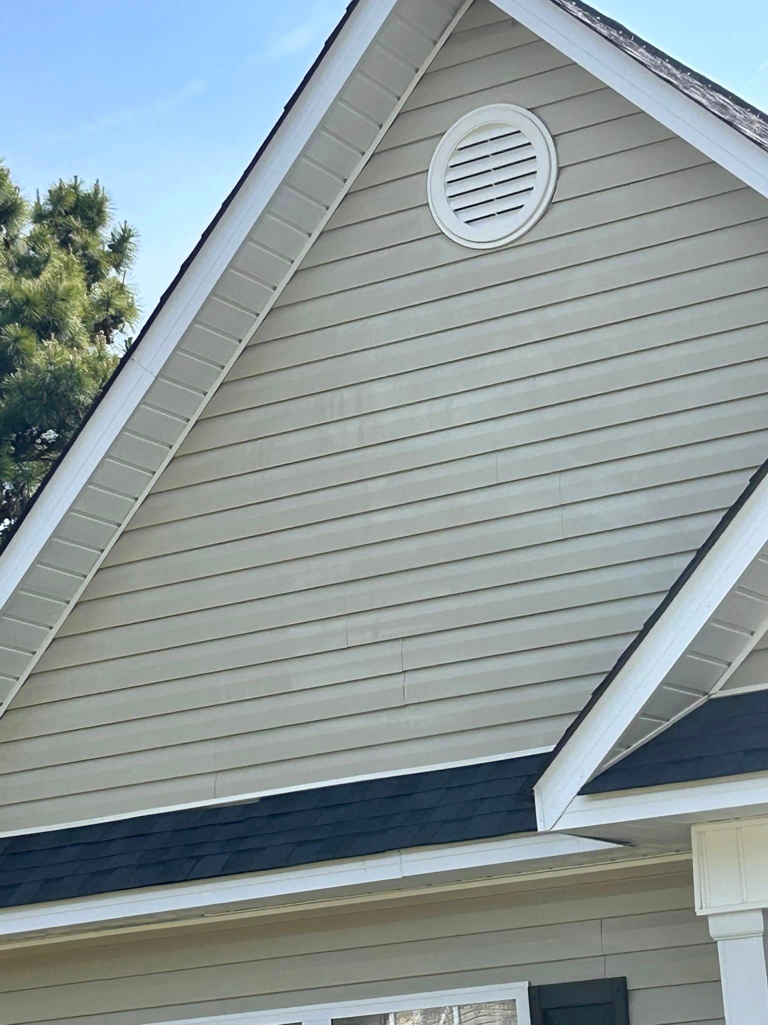 The roof of a house has a round vent on it