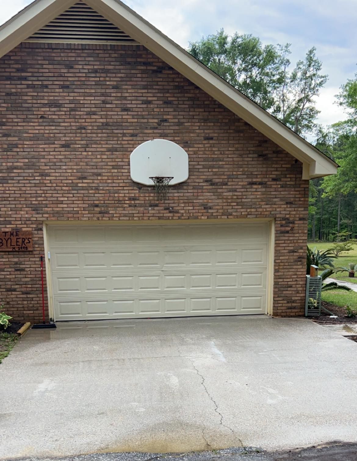 A garage with a basketball hoop on the side of it