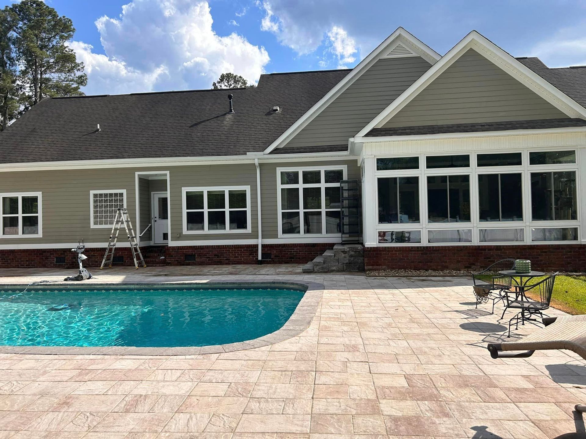 A large house with a swimming pool in front of it