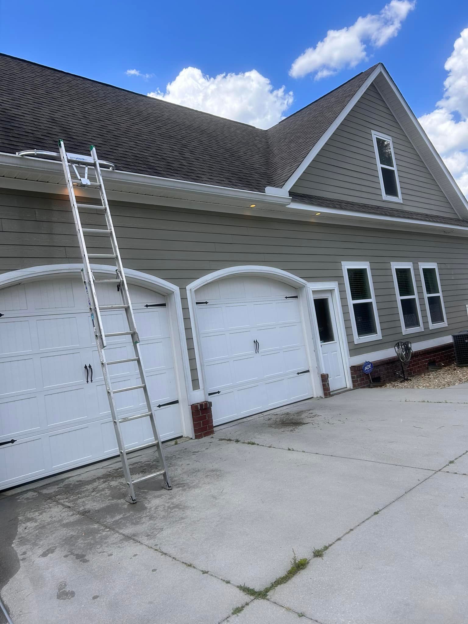 A ladder is leaning against the side of a house