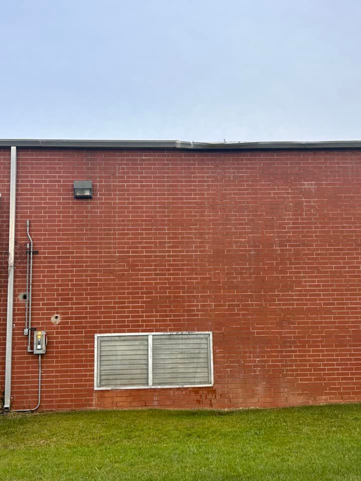 A red brick building with a window on the side of it.