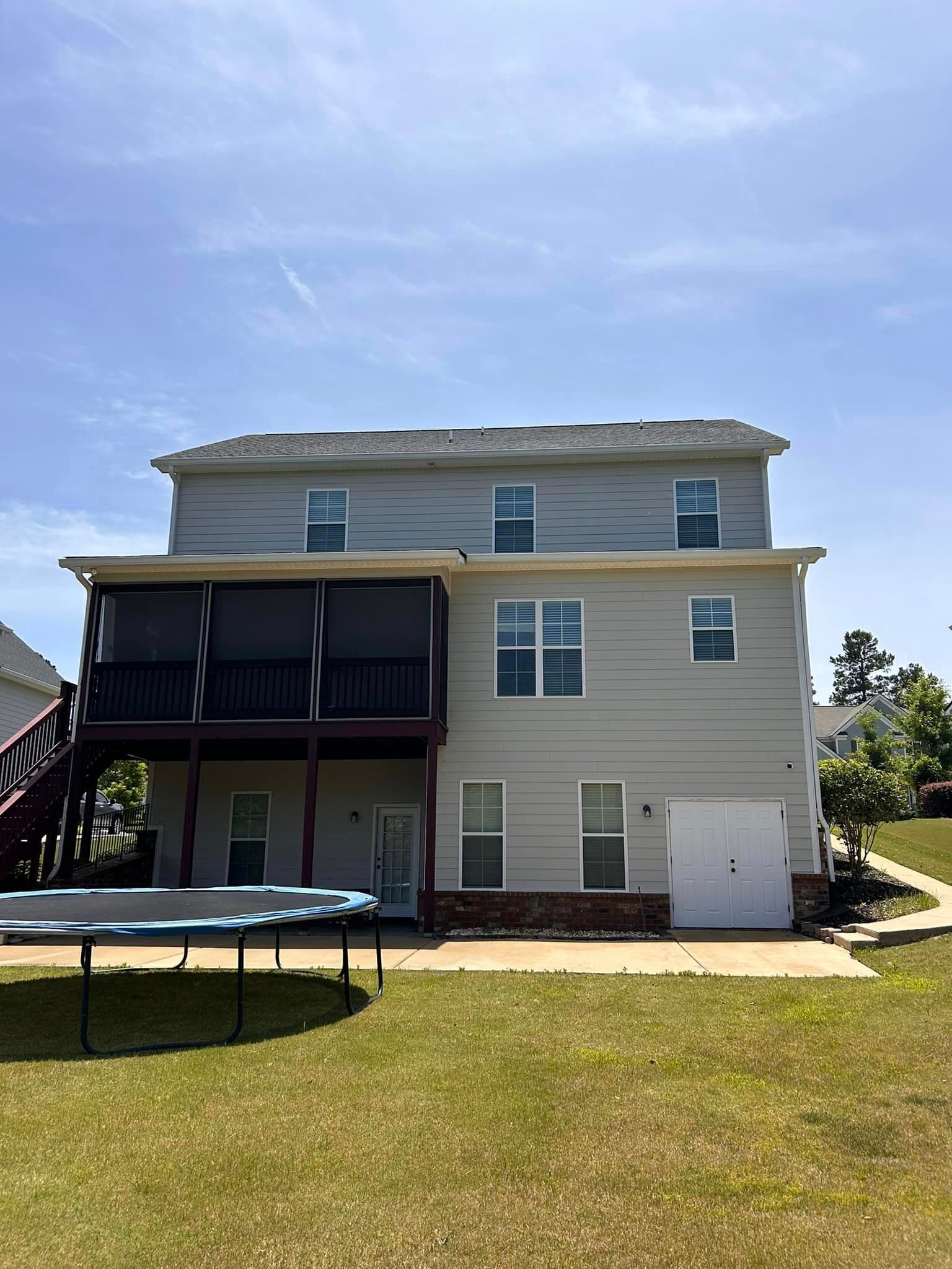 A large house with a trampoline in front of it.