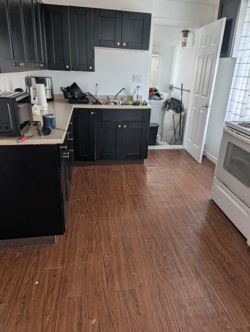 Person installing a door handle on a wooden door.