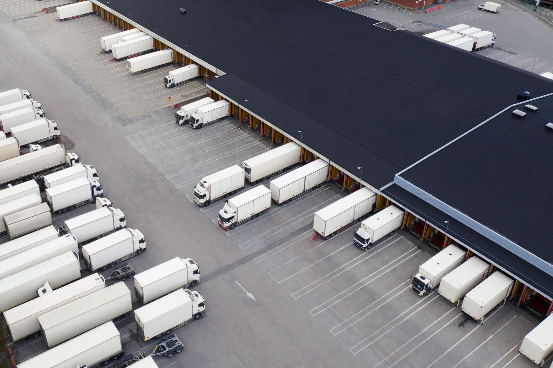 Large center with many trucks for trailer rental viewed from above