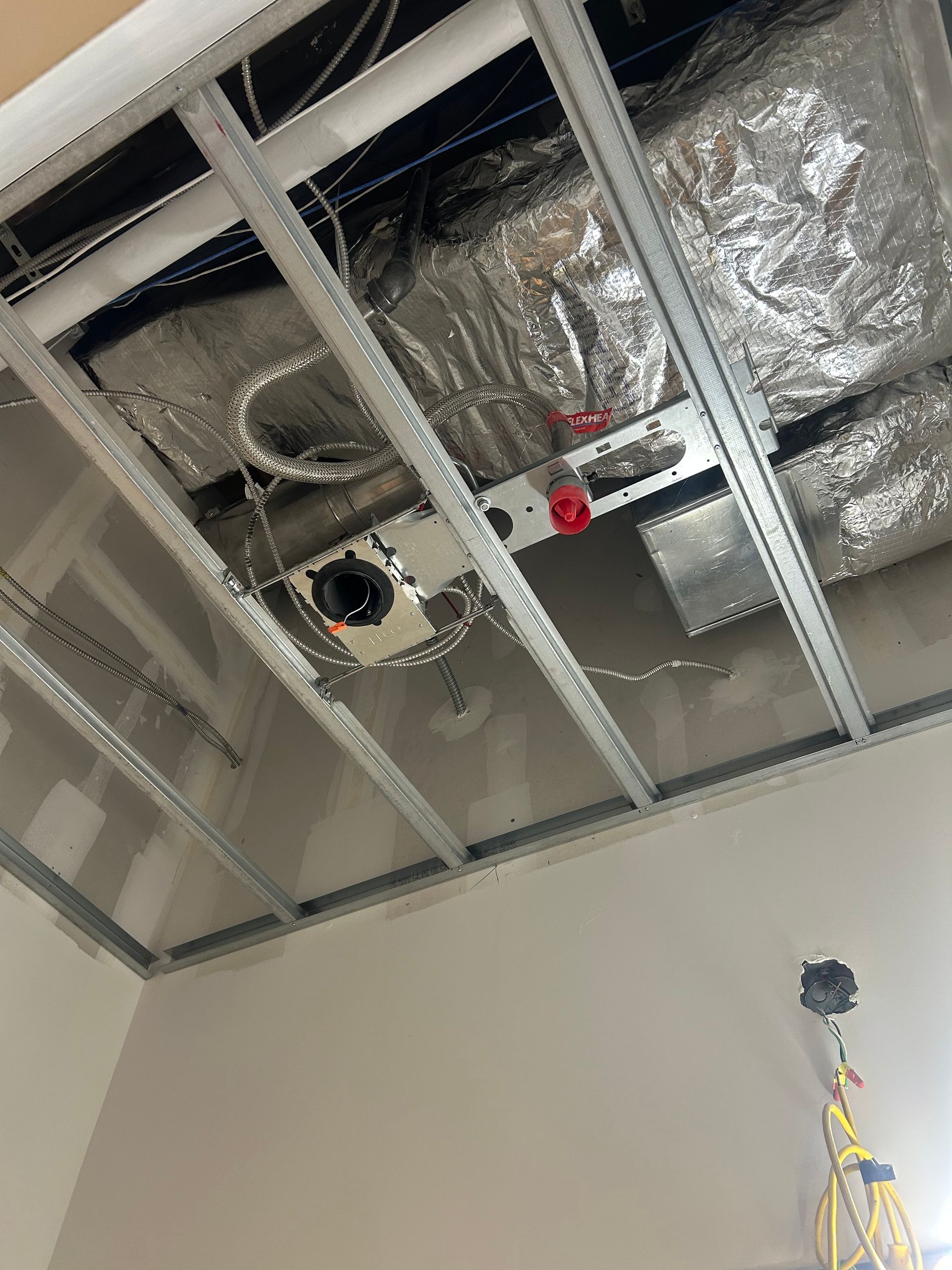 A ceiling with a lot of wires coming out of it.