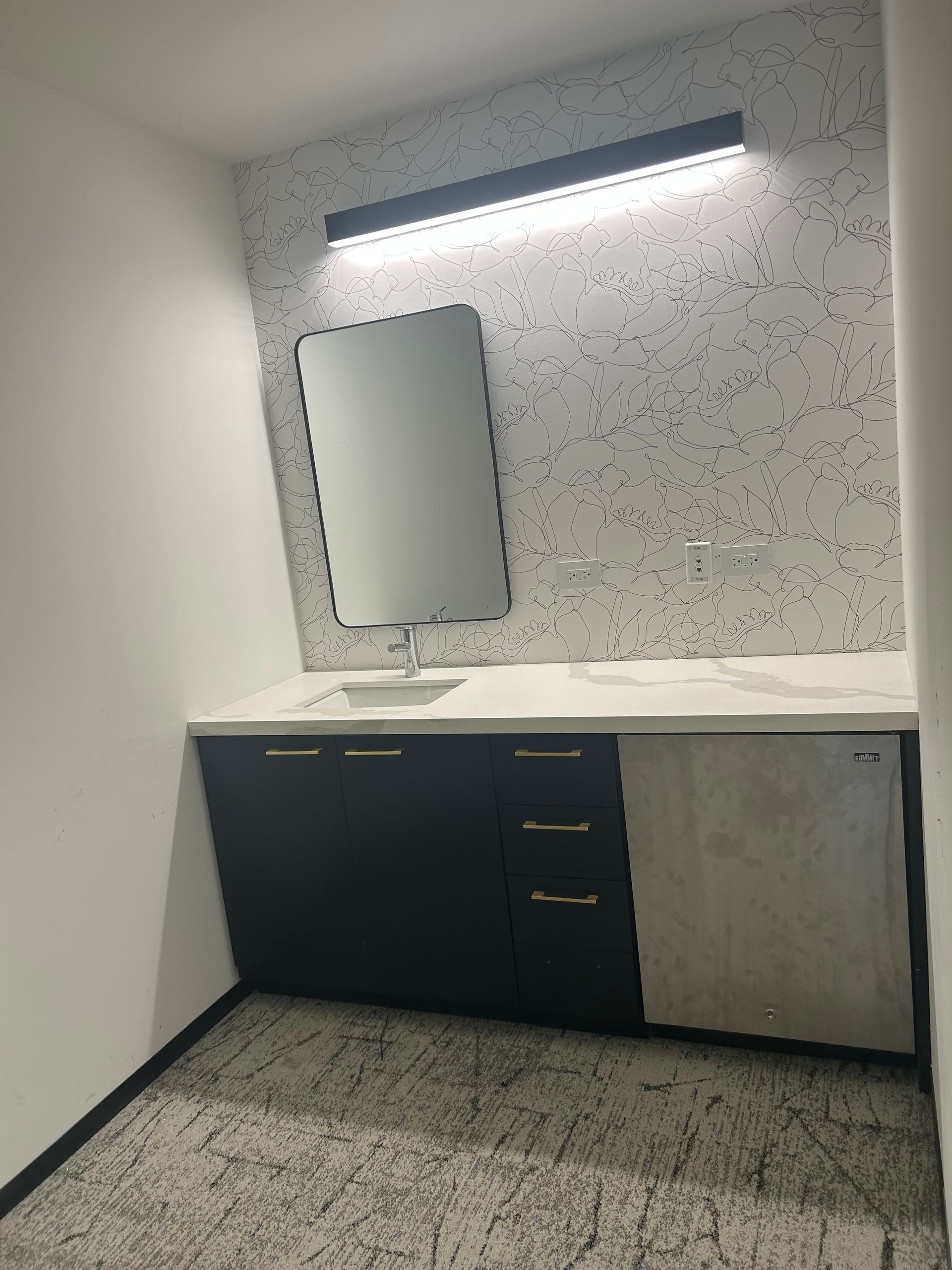 A bathroom with a sink and a mirror on the wall.