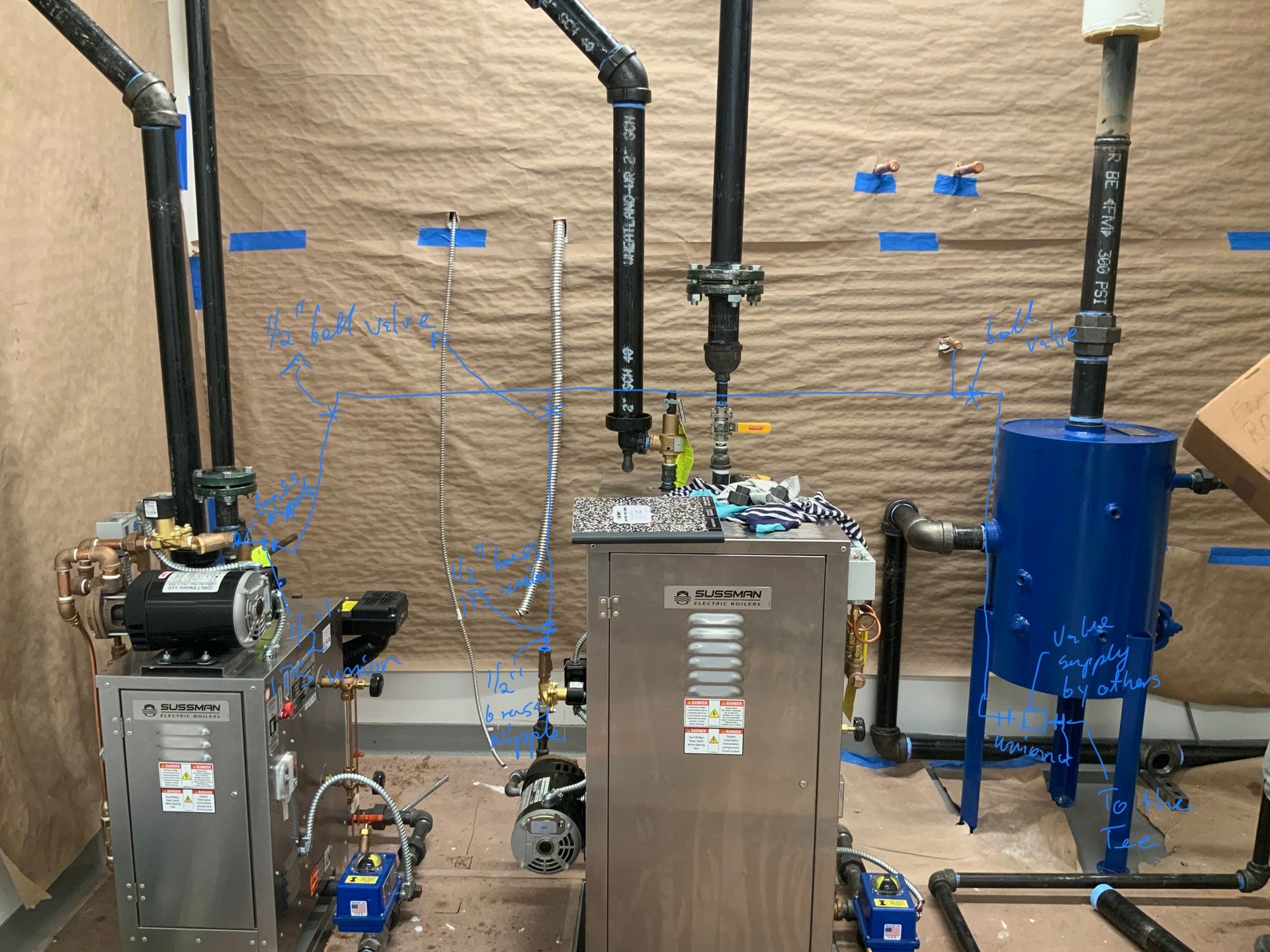 A room with a lot of pipes and a machine in it