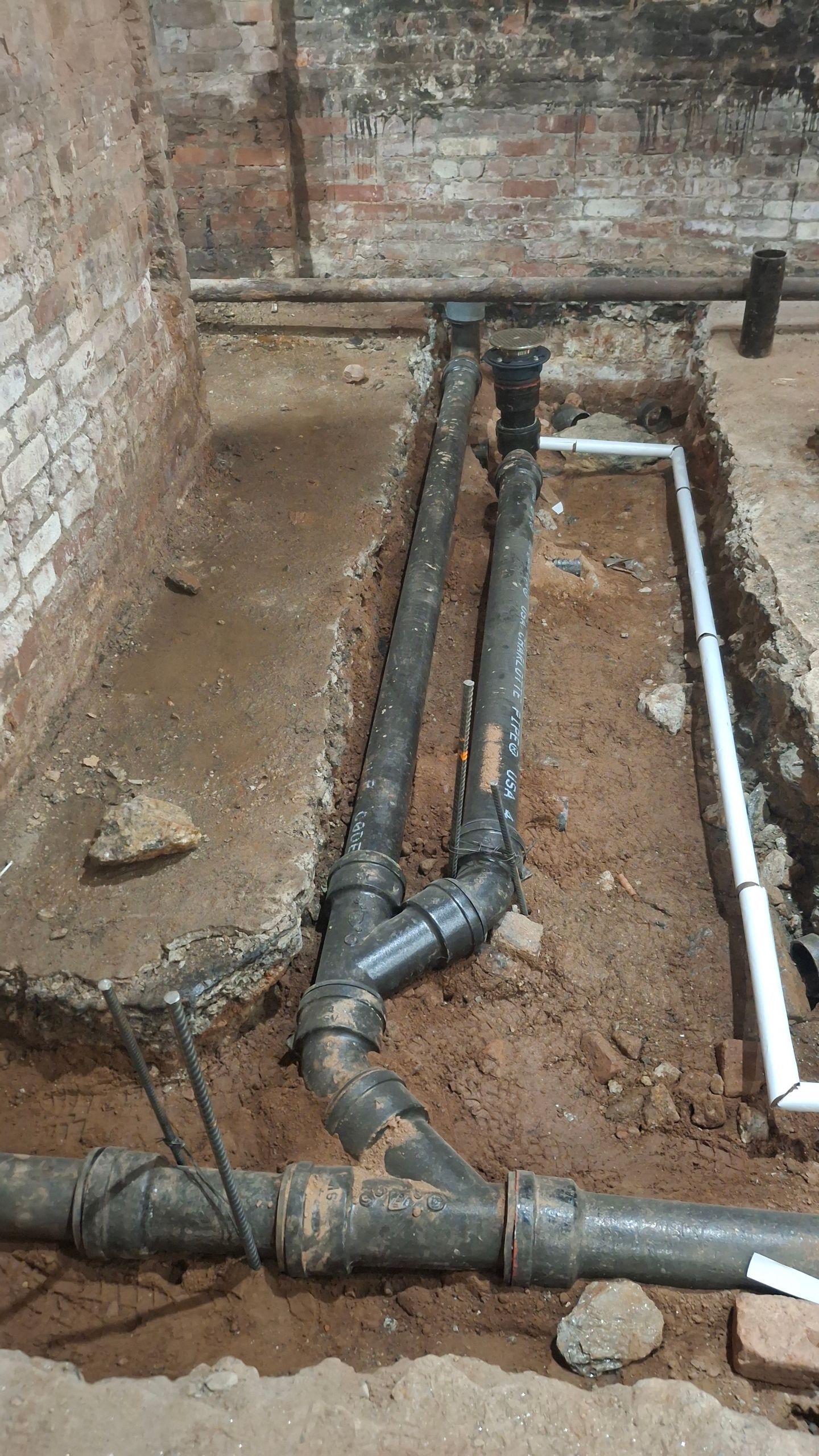 A bunch of pipes are being installed in a hole in the ground.