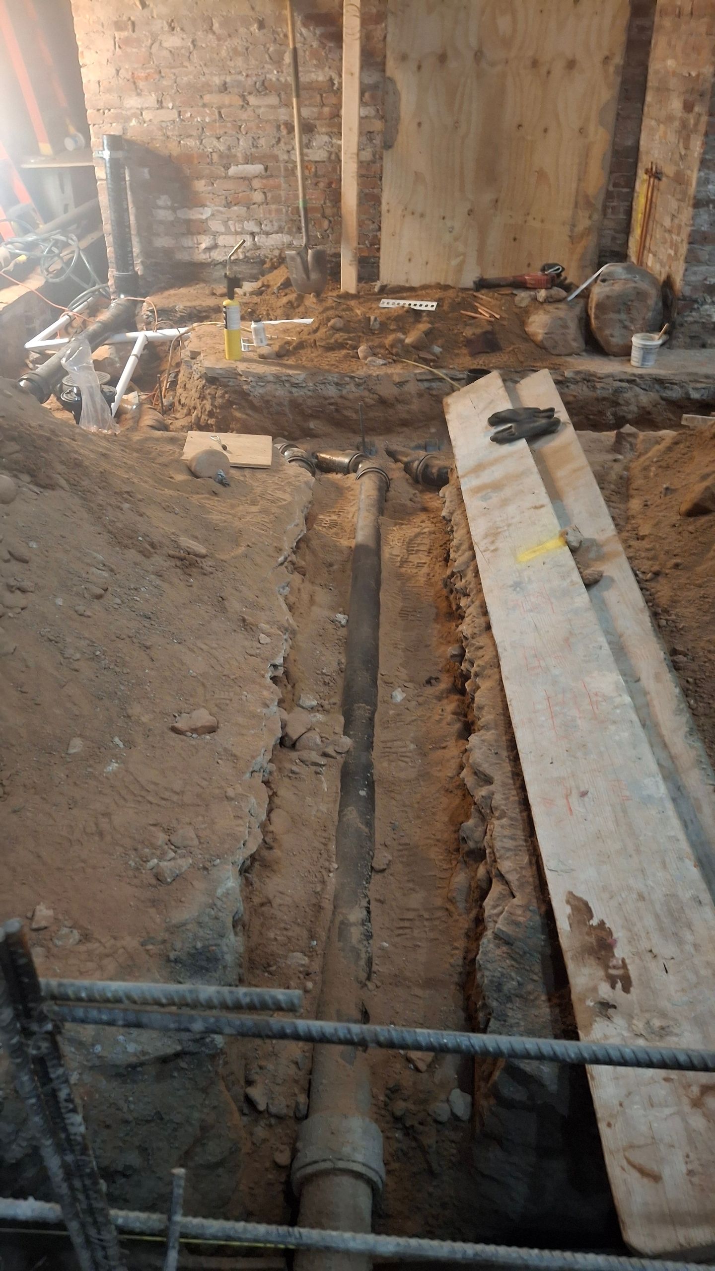 A pipe is being installed in a hole in the ground.