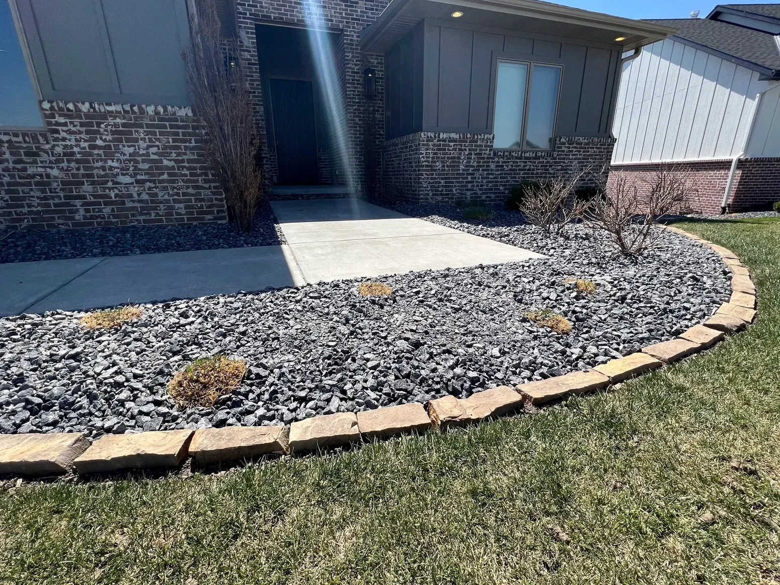 A Brick House with A Gravel Walkway — Exeter, NE — Axline Landscaping & Trees