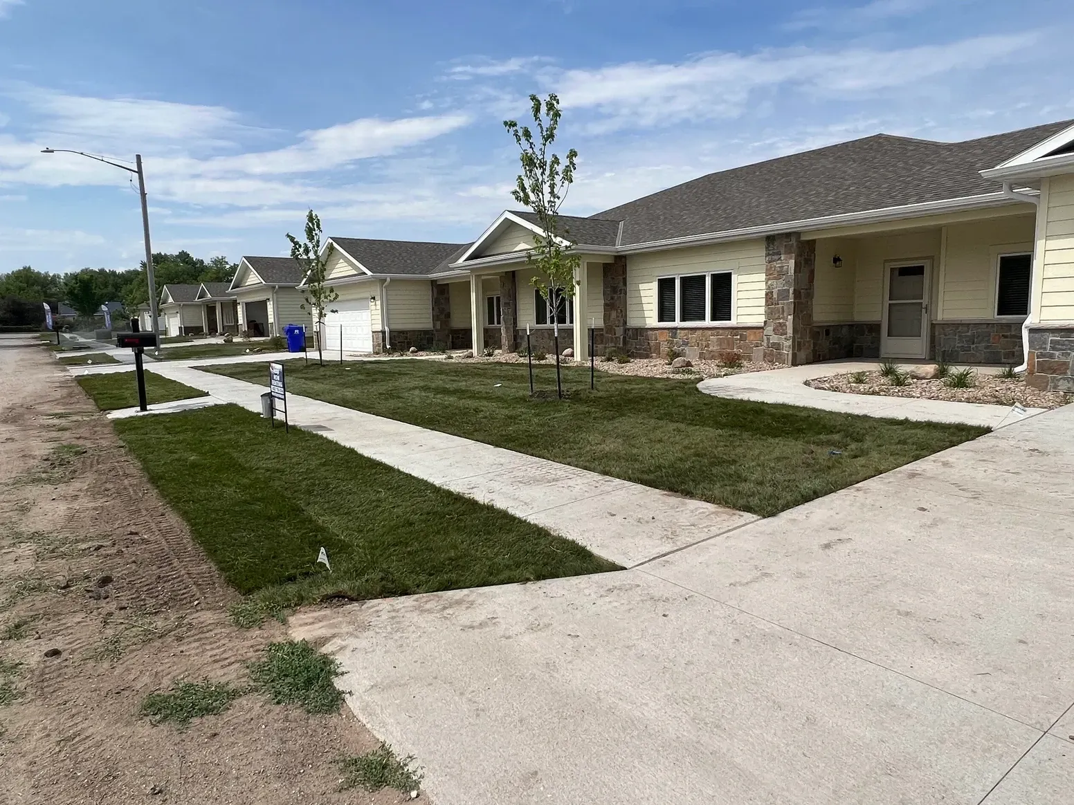 A Row of Houses with A Sidewalk — Exeter, NE — Axline Landscaping & Trees