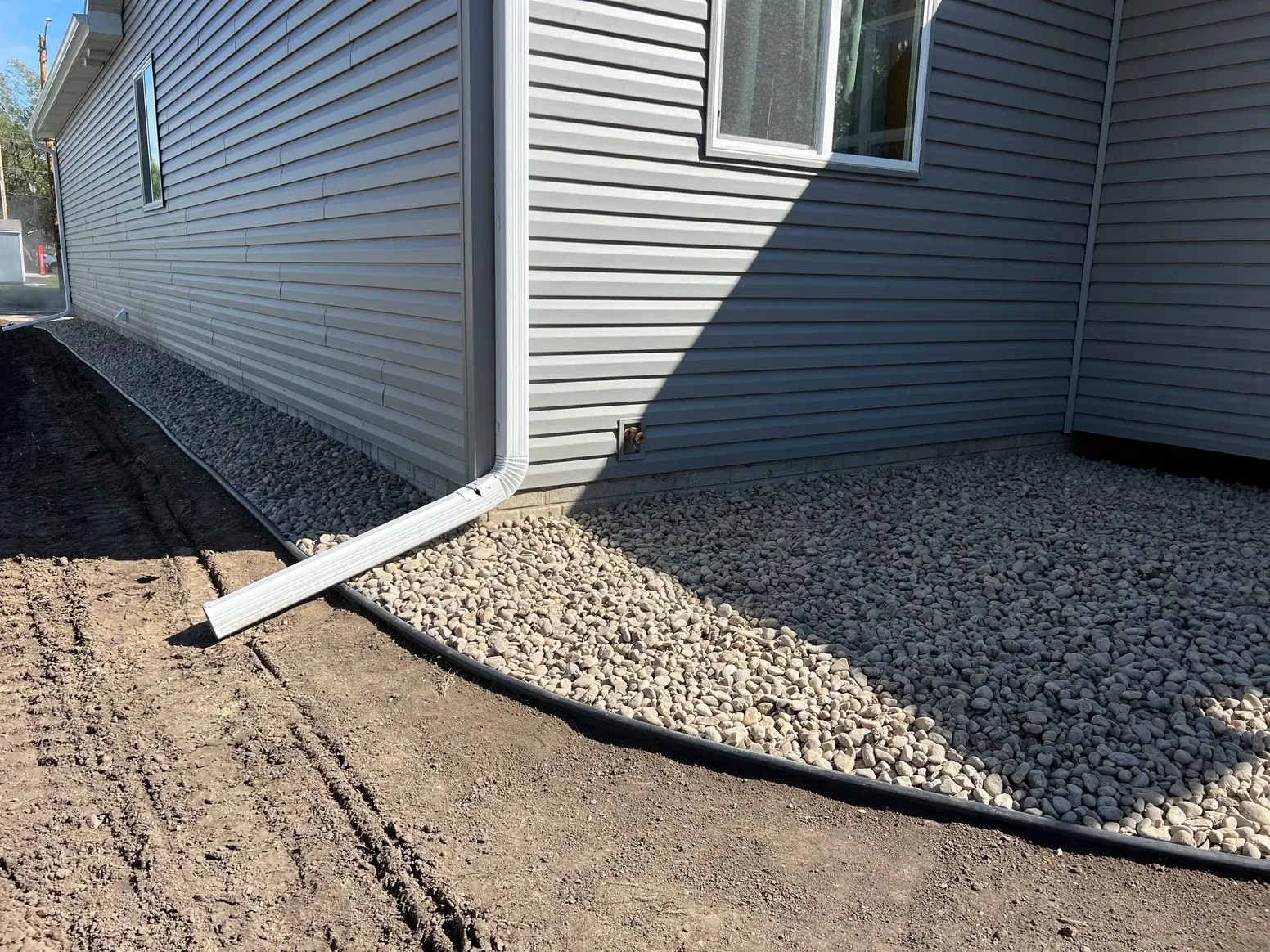 A House with A Drain Pipe — Exeter, NE — Axline Landscaping & Trees
