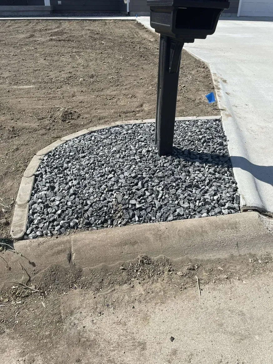 A Mailbox on Top of A Pile of Gravel Next to A Sidewalk — Exeter, NE — Axline Landscaping & Trees