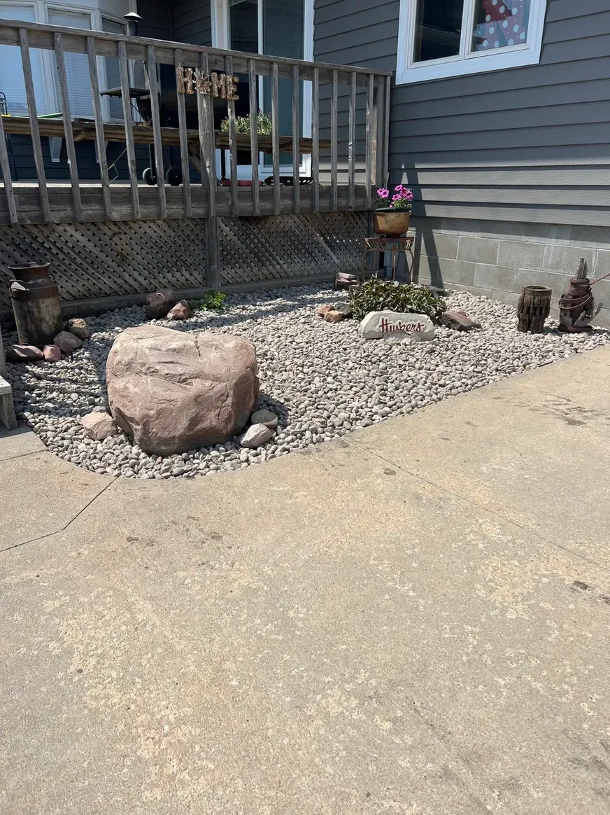 Large Rock in The Middle of A Gravel Yard in Front of A House — Exeter, NE — Axline Landscaping & Trees