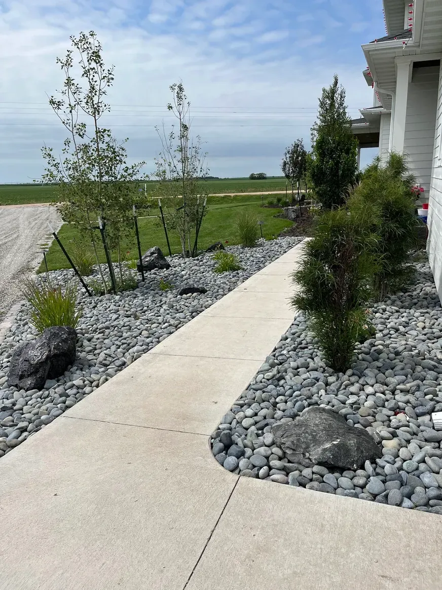 A Walkway Leads to A House Surrounded by Rocks and Trees — Exeter, NE — Axline Landscaping & Trees