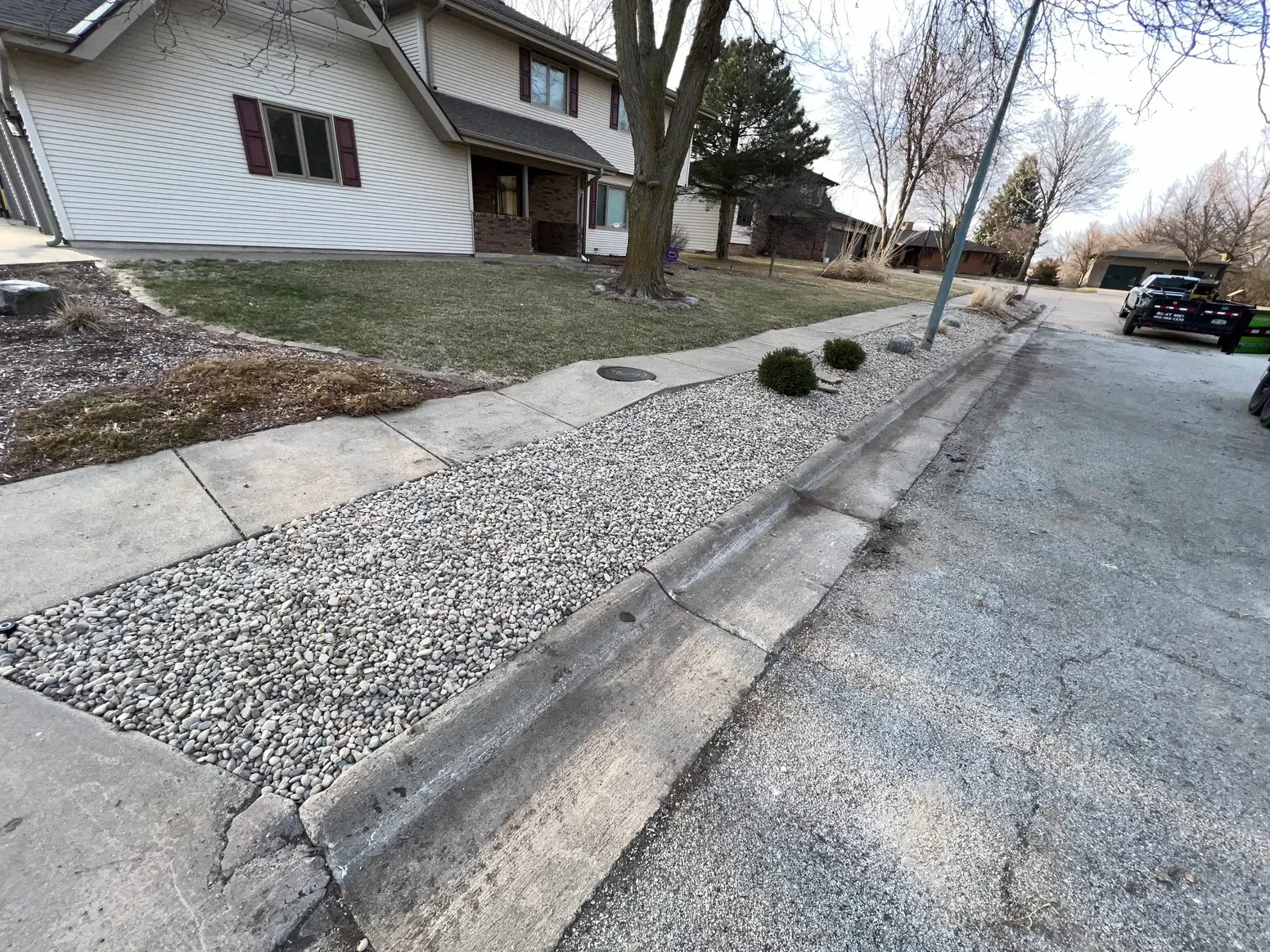 A Sidewalk with Gravel and A House — Exeter, NE — Axline Landscaping & Trees