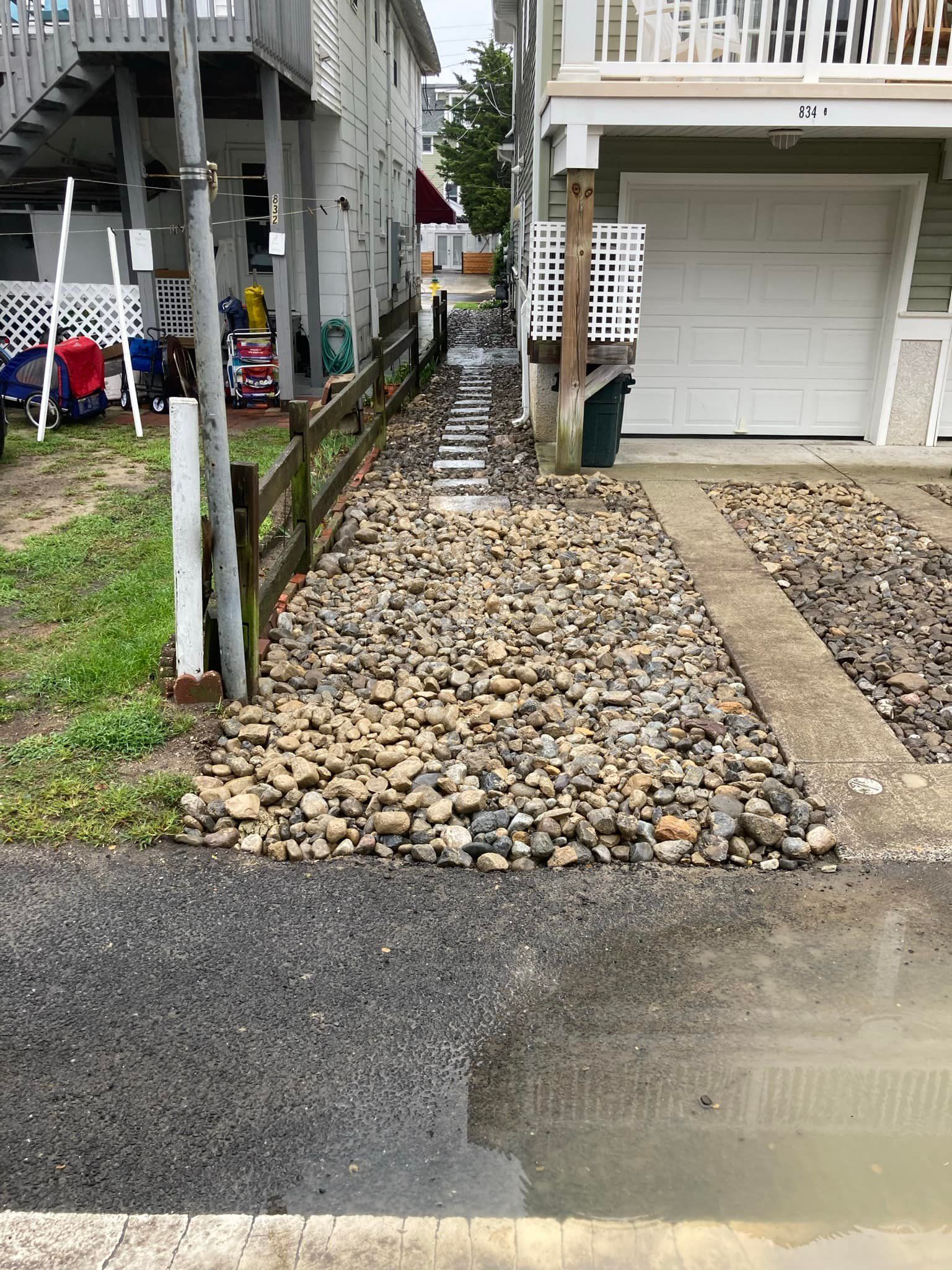 A driveway with a lot of rocks in front of a house