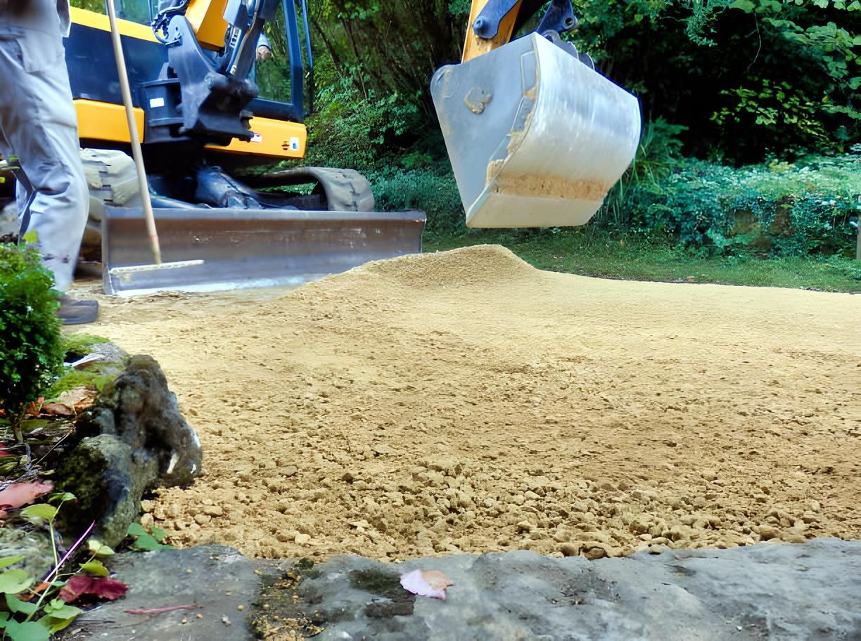 A large white bucket is being lifted by a yellow excavator