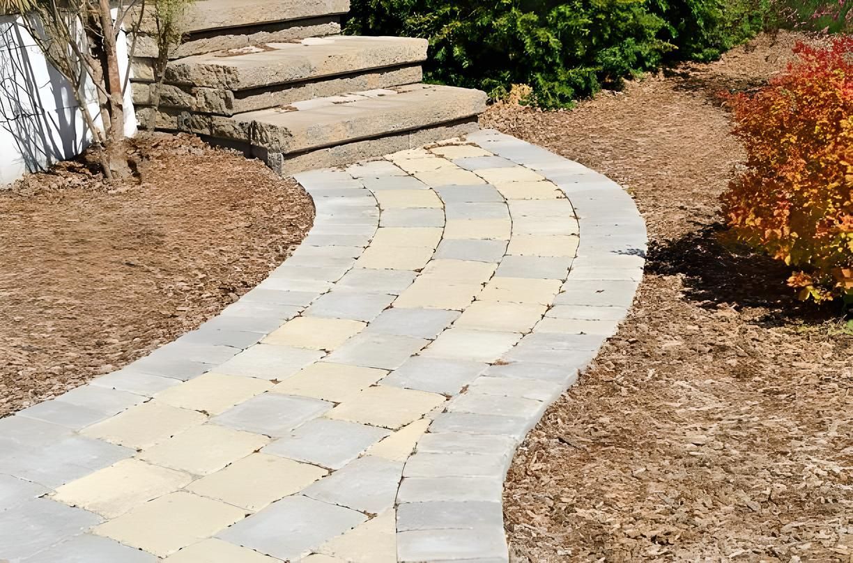 A brick walkway with a staircase in the background