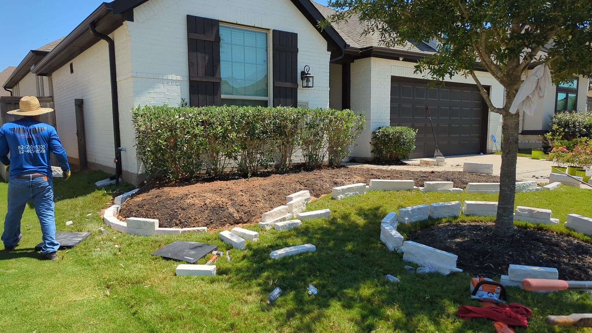 A man is standing in front of a white house.