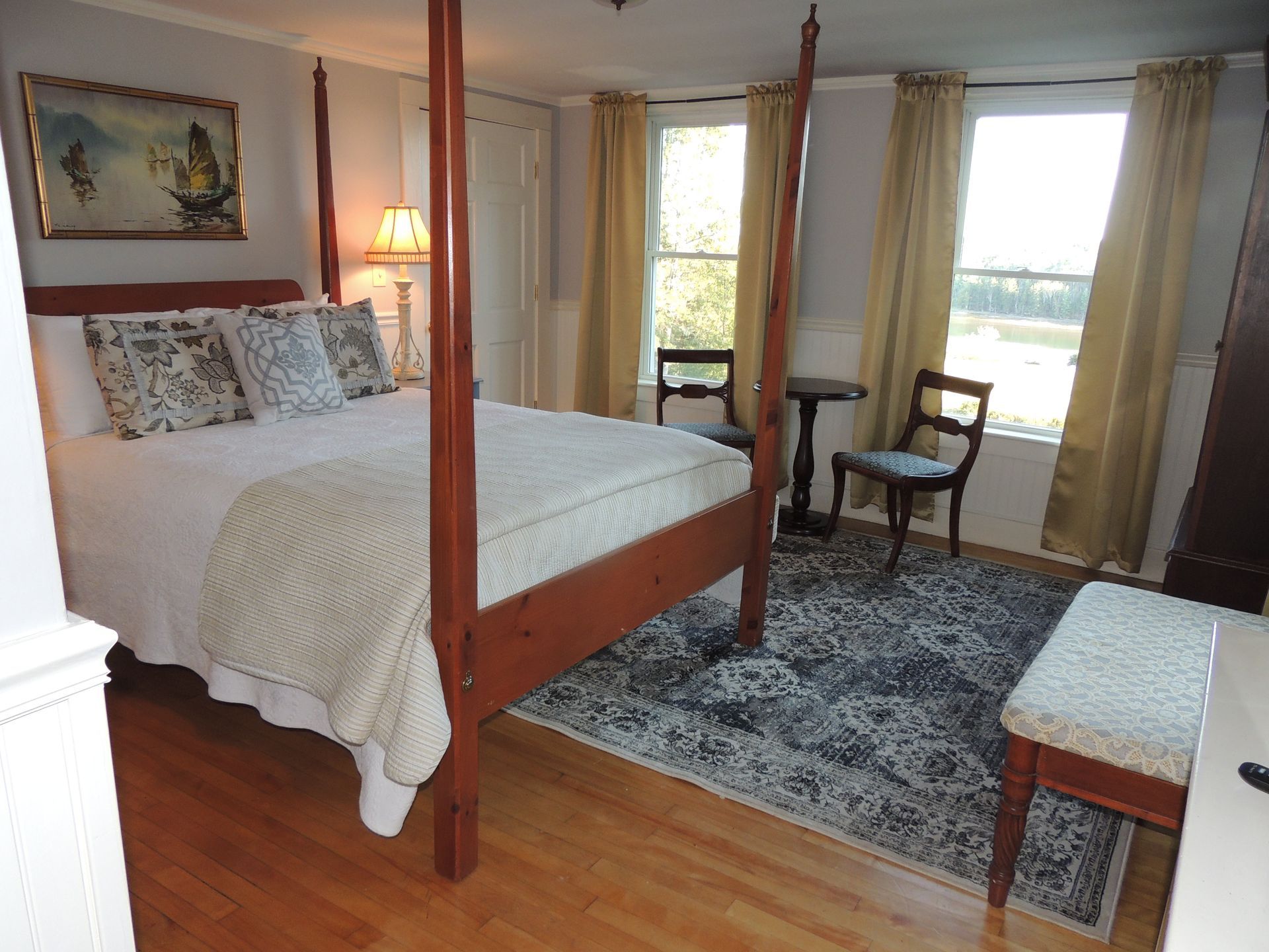 There is a four poster bed in the middle of the room.