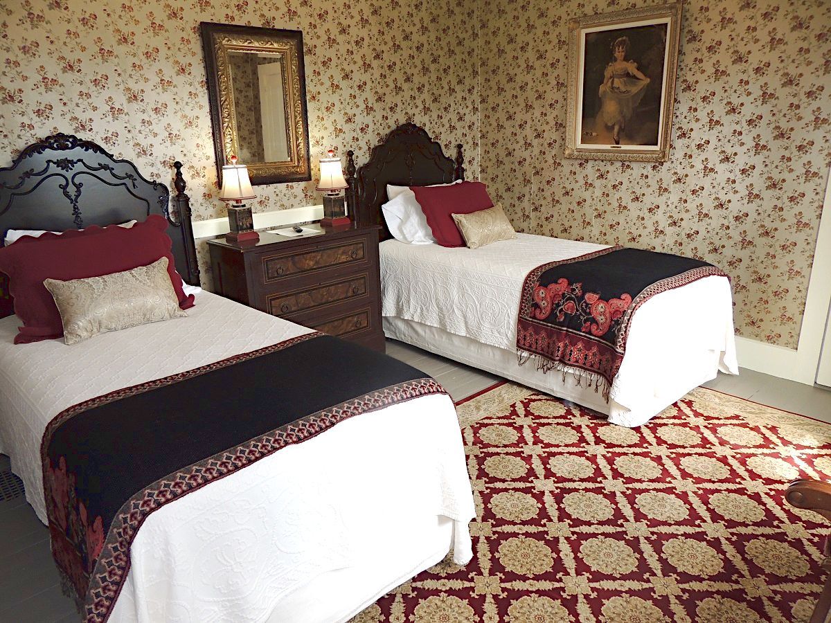 A bedroom with two twin beds and a rug