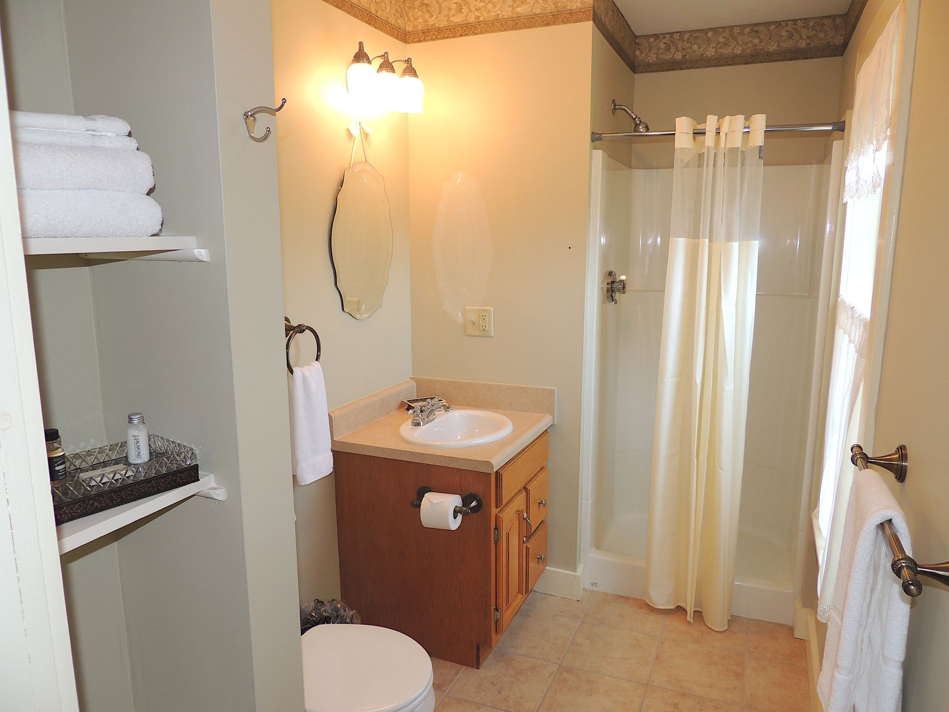 A bathroom with a toilet a sink and a shower